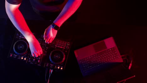 dj performance with mixer and laptop
