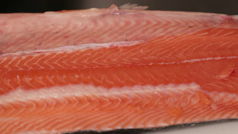 fresh raw salmon fish steak on top of a white table