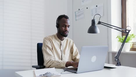 businessman working on laptop with headset