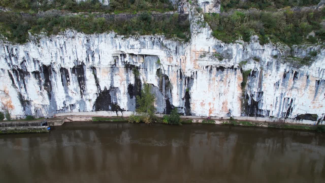 Towpath carved in rock by river, tranquil scene with historical roots