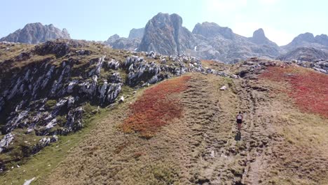 woman hikes uphill a mountain trail in prokletije national park, montenegro - dolly