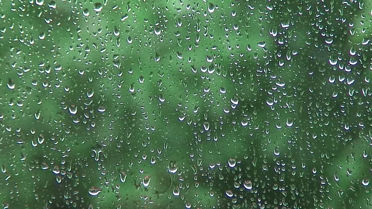 Rain running down a window during a heavy rain storm in the UK