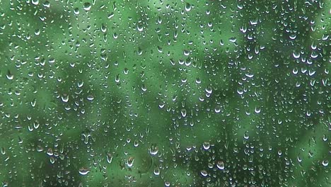 rain running down a window during a heavy rain storm in the uk