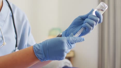 video of hands of biracial female doctor preparing vaccine