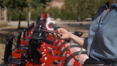 woman using a mobile app to unlock a bike