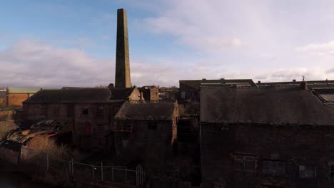 aerial footage of an old abandoned, derelict pottery factory and bottle kiln located in longport, stoke on trent, staffordshire