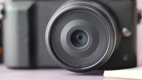 a black  mirrorless camera and lens on white background ,