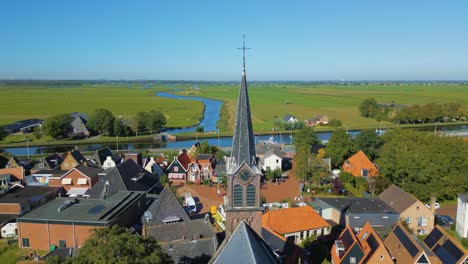 orbit to right of church steeple in christian north holland village landsscape