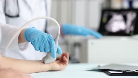 medical professional performing ultrasound examination on patient's arm