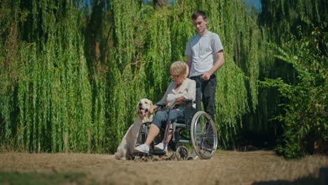 woman in wheelchair with dog and caregiver in park