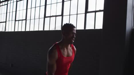 African-american-man-running-with-passion-in-an-empty-urban-building