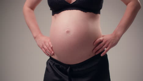 woman in advanced pregnancy poses calmly