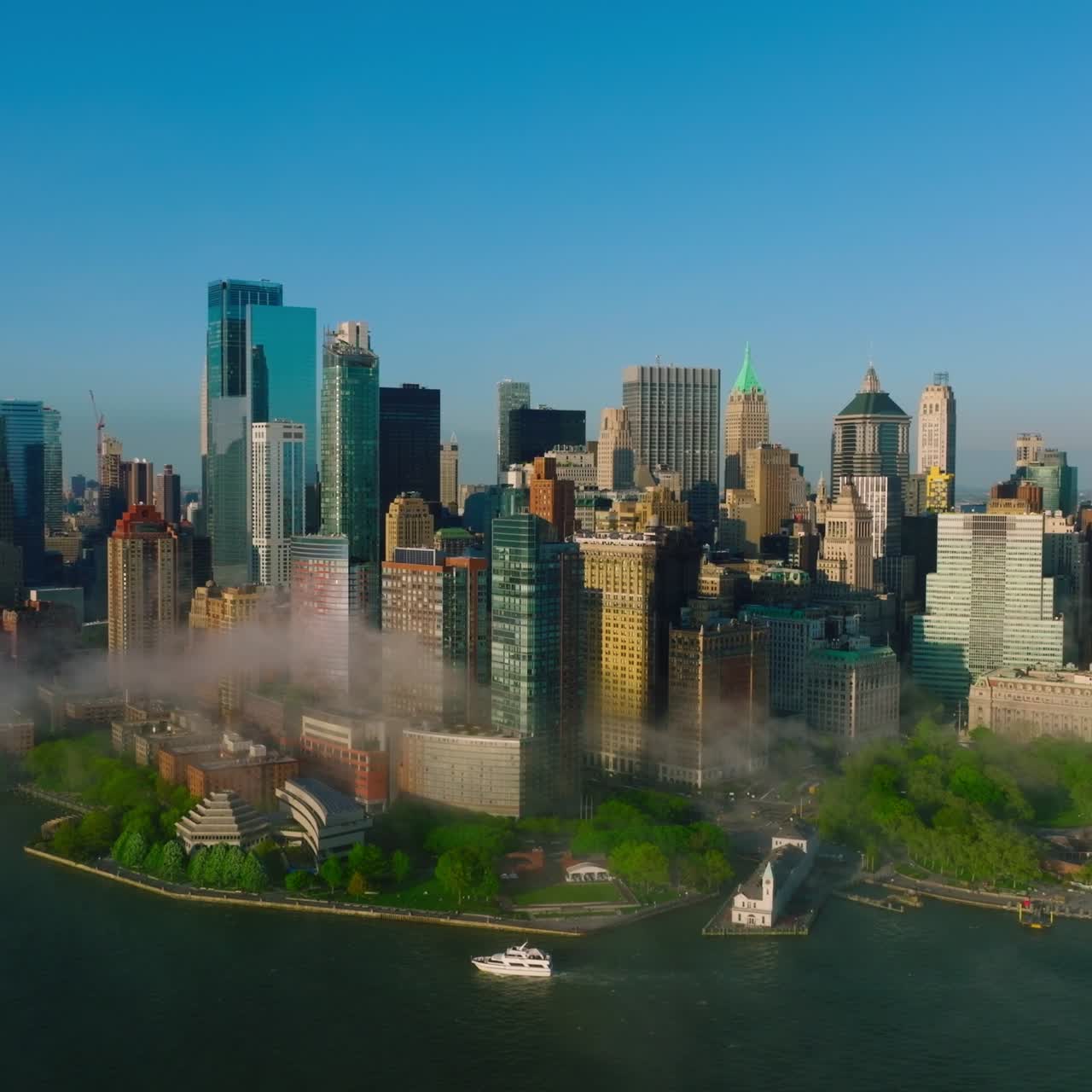 New modern creative buildings of Manhattan Island. Flying along the waterfront built up with numerous buildings covered with slight fog