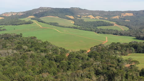 Drone-aeral-shot-going-up-revealing-scenic-panoramic-view-of-rolling-countryside-green-farm-fields