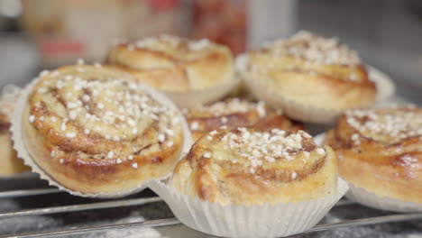 Male-hand-picking-up-a-cinnamon-bun