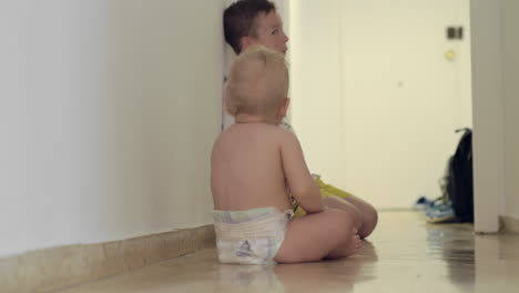 boy playing with baby sister at home