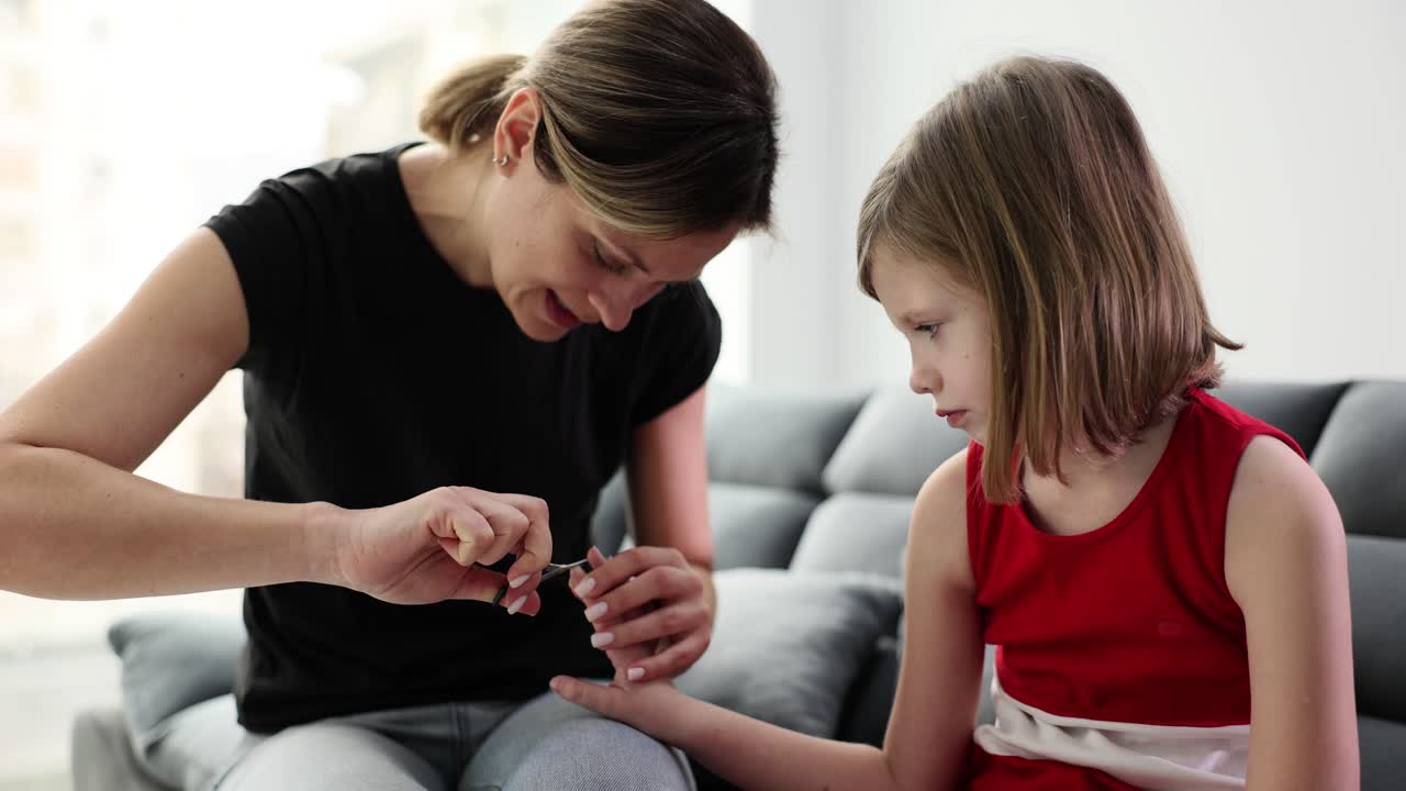 Mother helps child with home blood glucose testing for diabetes management