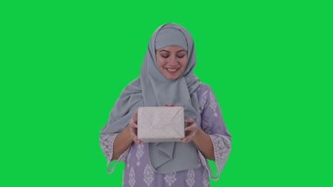 happy muslim woman receiving a gift green screen