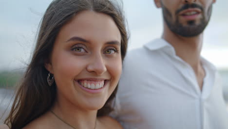 tender newlyweds enjoy ocean stormy beach closeup. woman face smiling camera