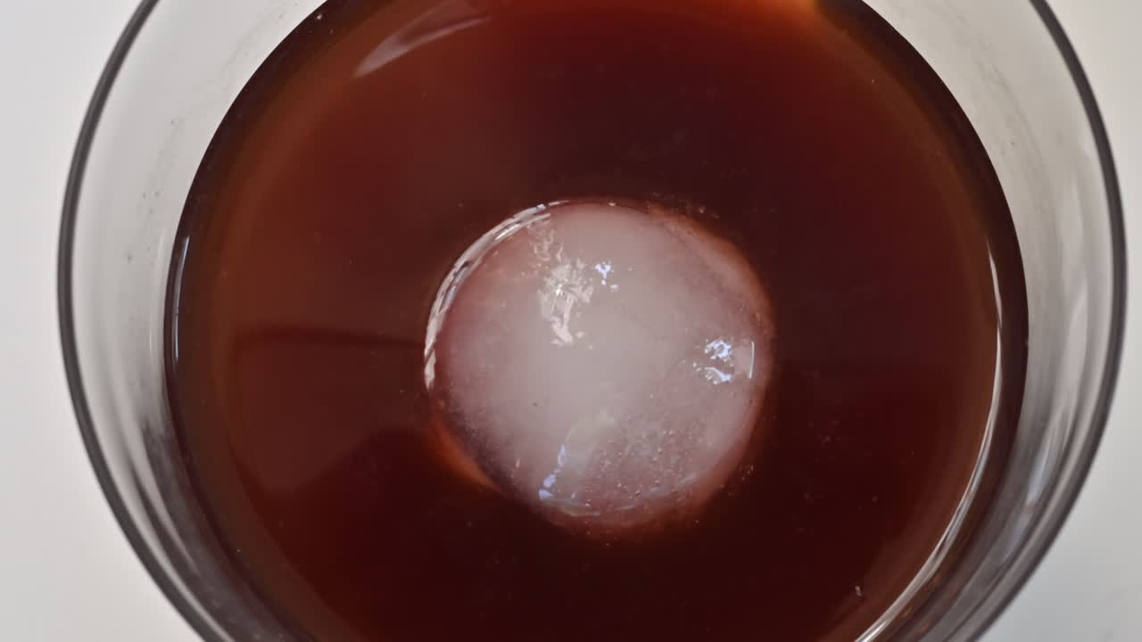 Close up glass with cold brew coffee and round ice drink