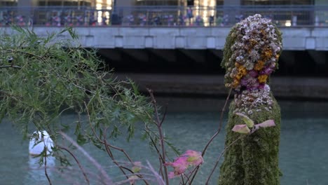 floral moss sculpture by the river in a city setting