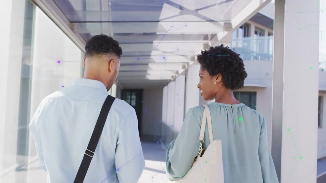 Two colleagues exiting walkway and moving between campus into passage, tech network overlaying tote