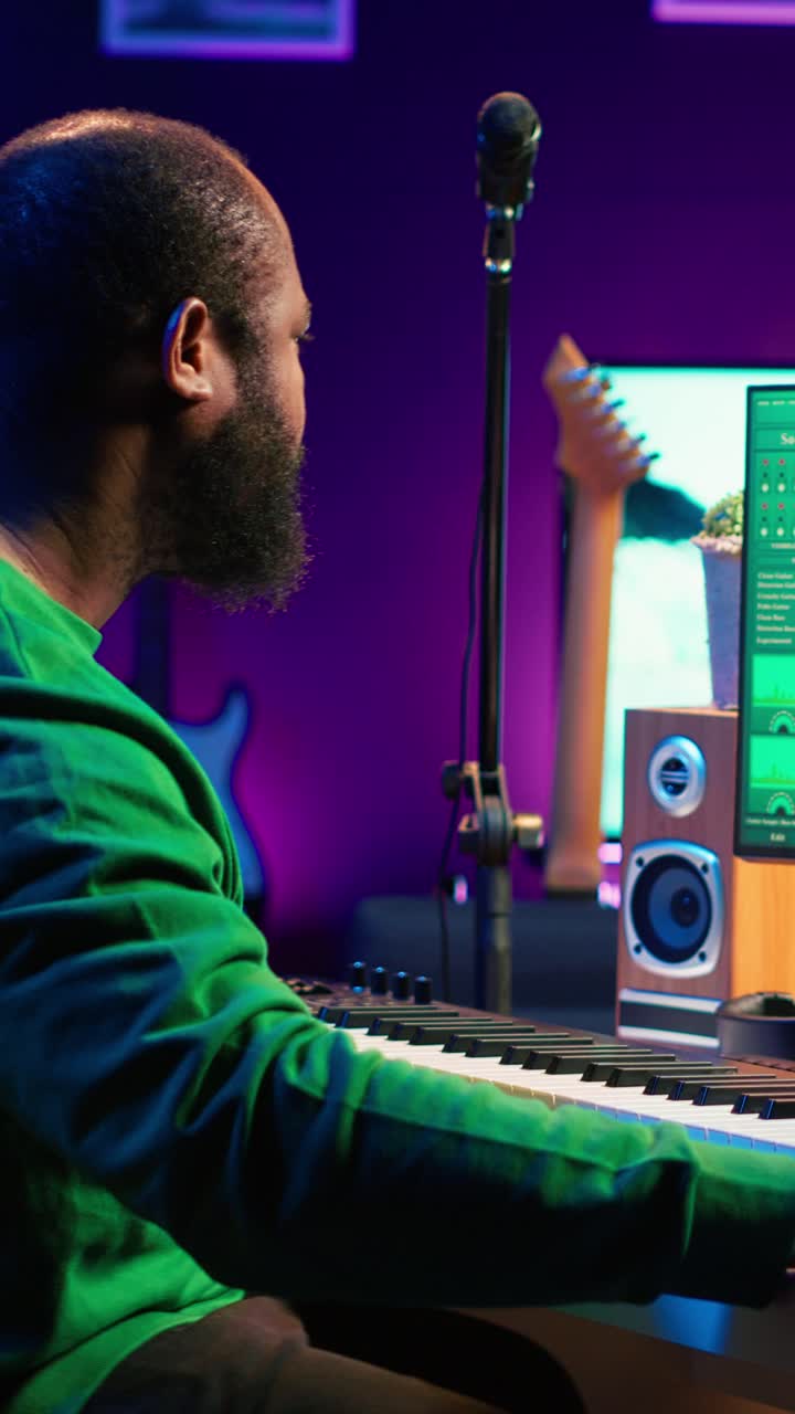 African American Man Playing Electronic Keyboard in Music Studio
