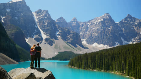 Couple-standing-on-a-rock-near-riverside-4k