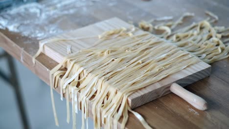 chef's flour-coated tagliatelle sorting in cinematic slow motion - culinary masterpiece - 4k