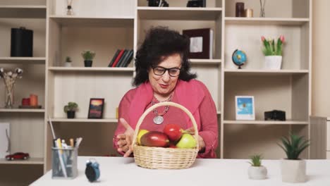 old woman receives a basket of fruits from a young man, rejoicing with a smile