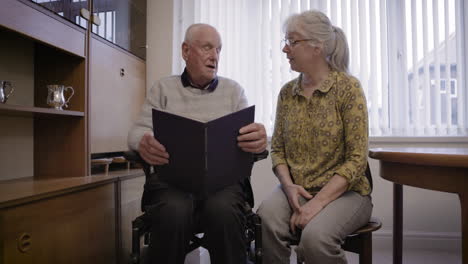 elderly couple looking through a photo album