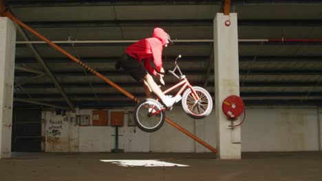 bmx rider in an empty warehouse