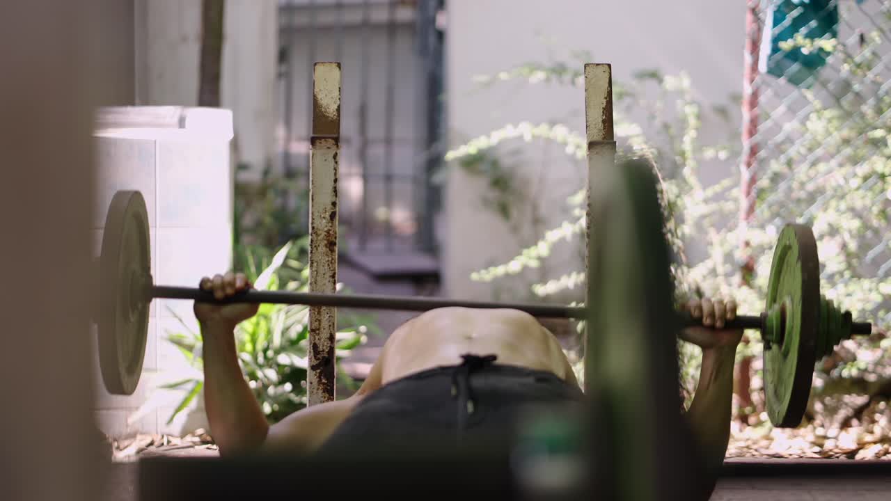 Man Bench Pressing a Barbell