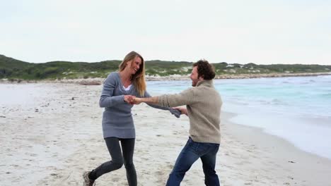 happy couple running and laughing on the beach