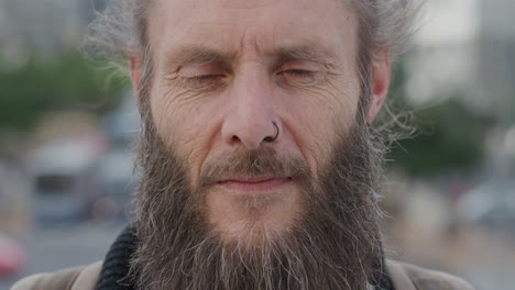 close-up-portrait-mature-bearded-hippie-man-looking-up-pensive-homeless-guy-living-independent-urban-lifestyle-in-city-wearing-nose-ring-wrinkles-aging