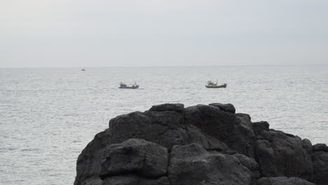 small fishing boats and fishermen sail on the pacific ocean in vietnam