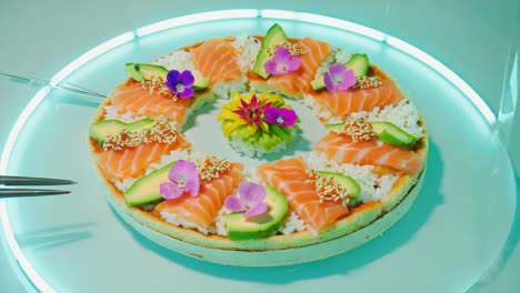 sushi cake with salmon, avocado and flowers