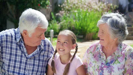 happy grandparents with granddaughter