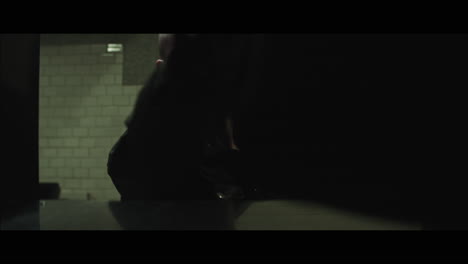 a bald dangerous looking man opens train station locker