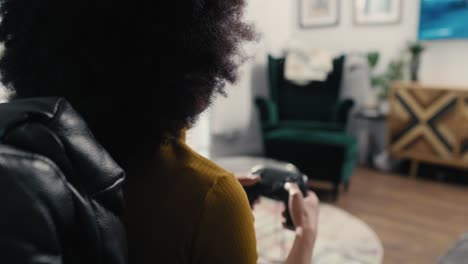 Back-view-of-teenage-girl-playing-video-game-in-the-living-room