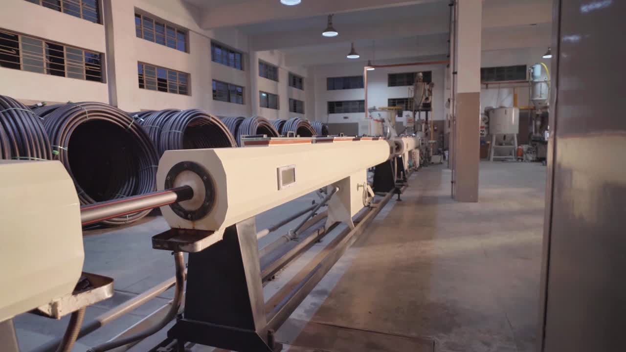 Long black PVC pipes manufactured kept in rolls inside a PVC Pipe Making Factory in Karachi Pakistan.