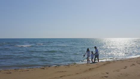 family and couple on the beach