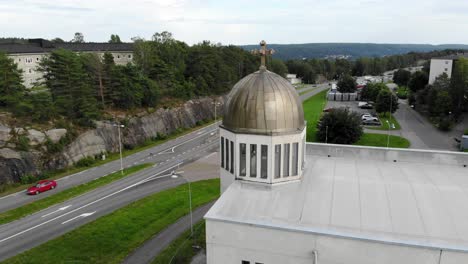 scenic view of the small town church with moving cars in the street