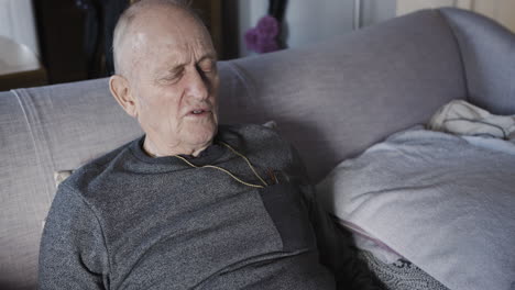 Elderly man relaxing on couch