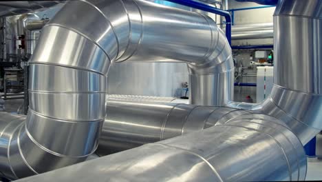 Slider-shot-of-large-industrial-tubing-and-piping-inside-central-heating-plant