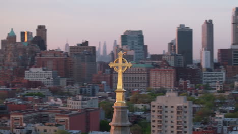 aerial view of a crucifix on top of a church steeple in new york city