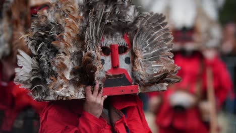 wooden masks with birdy feathers and red noses