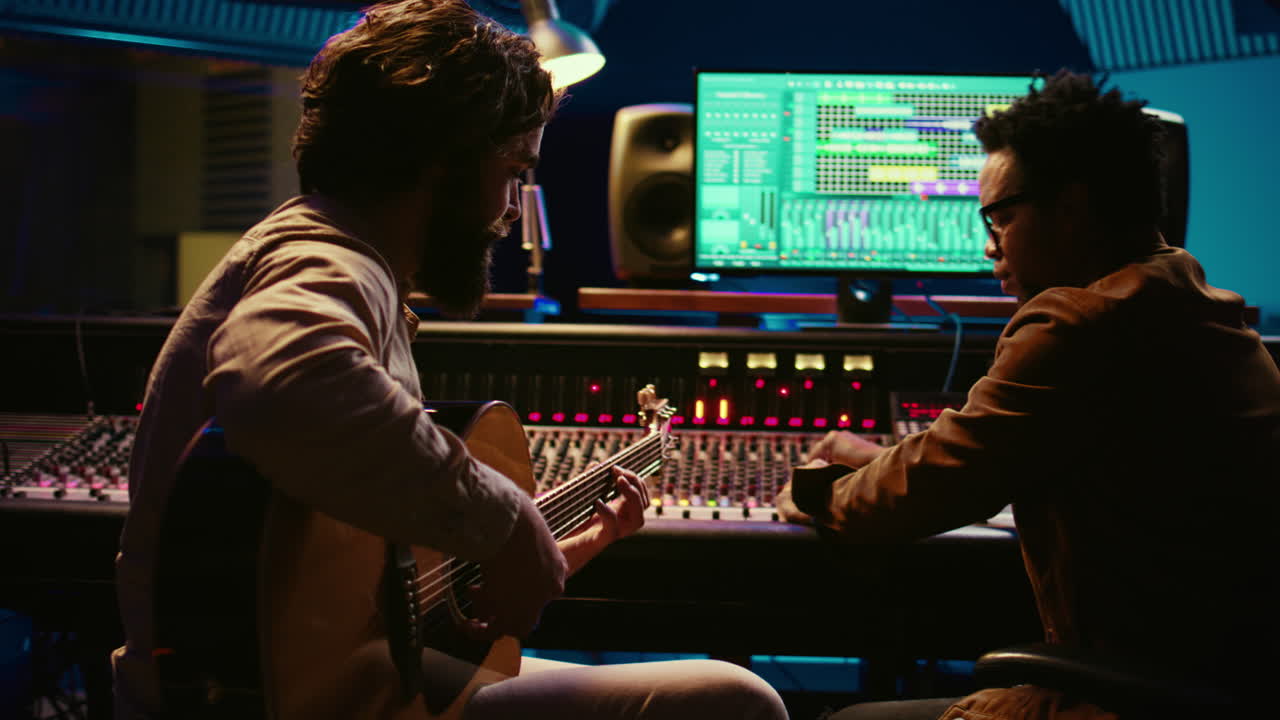 Artist songwriter recording a new track on his electro acoustic guitar