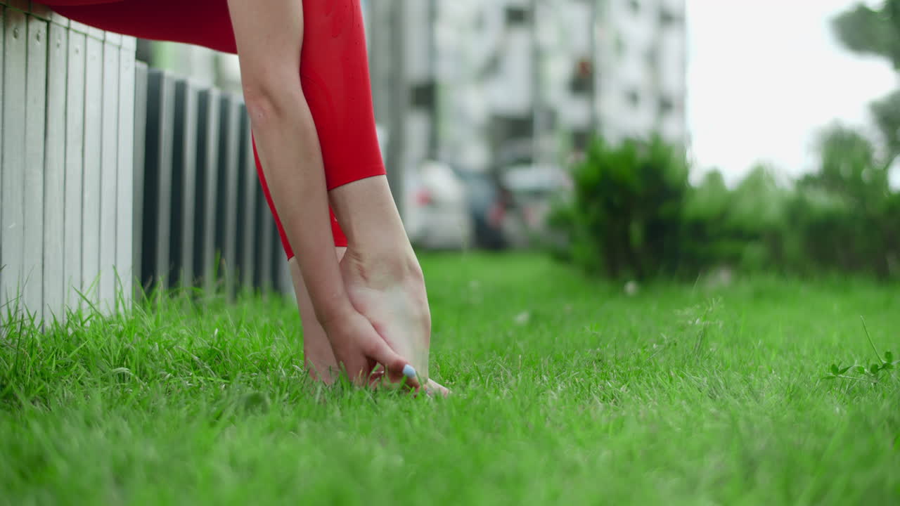 Woman Stretching Her Feet in a Park