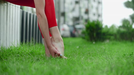 woman stretching her feet in a park